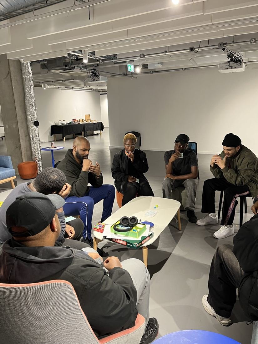 Students and a coach sitting in a circle for a careers discussion.
