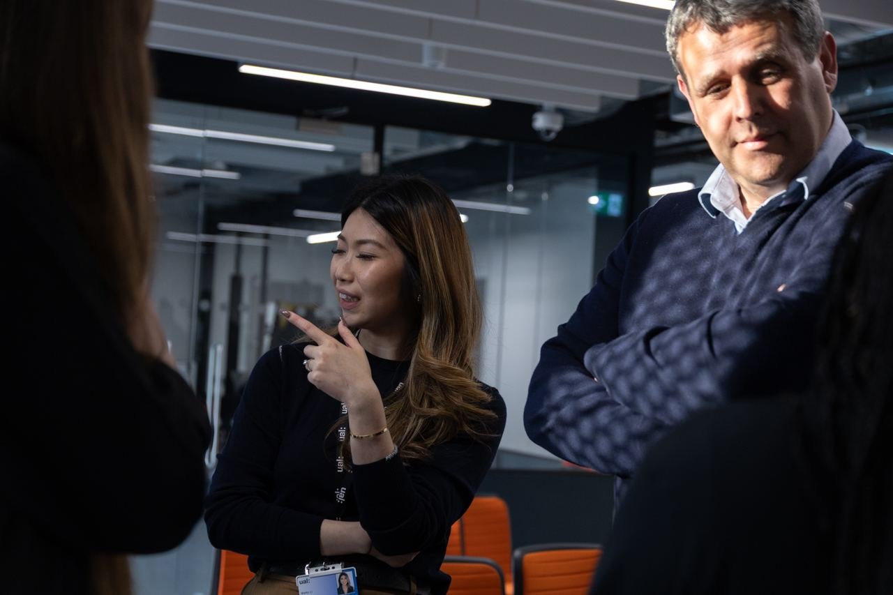 A UAL staff member chats with a guest at a Peckham DAZ event.