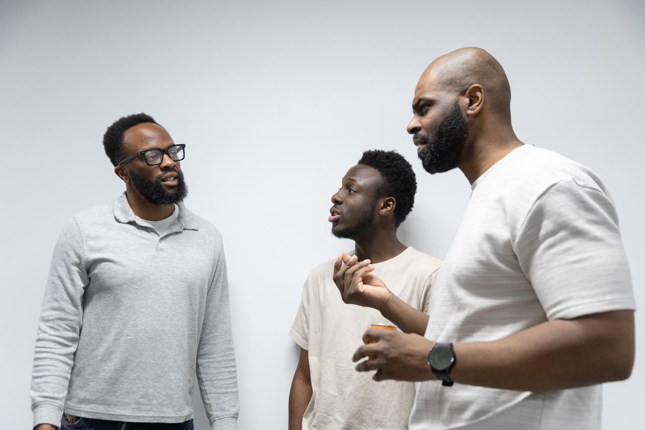 Three people talking together at a Peckham DAZ networking session.