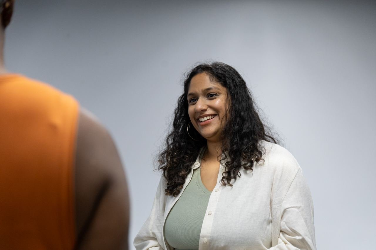 A student smiling during a conversation.