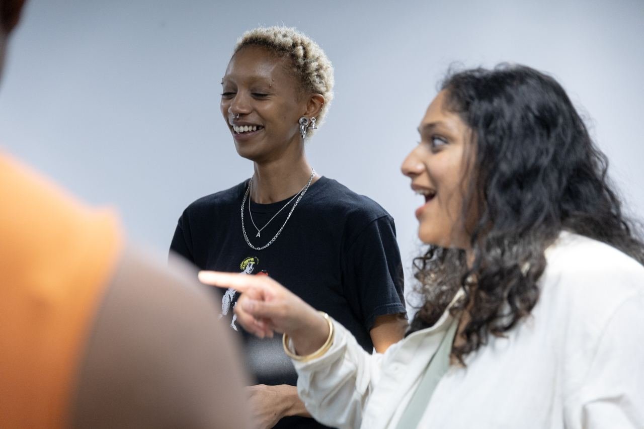 Two students share a laugh during a networking break.